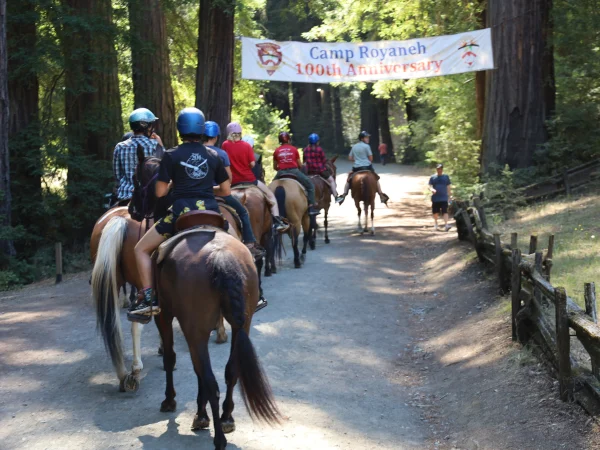 horse riding under 100th banner